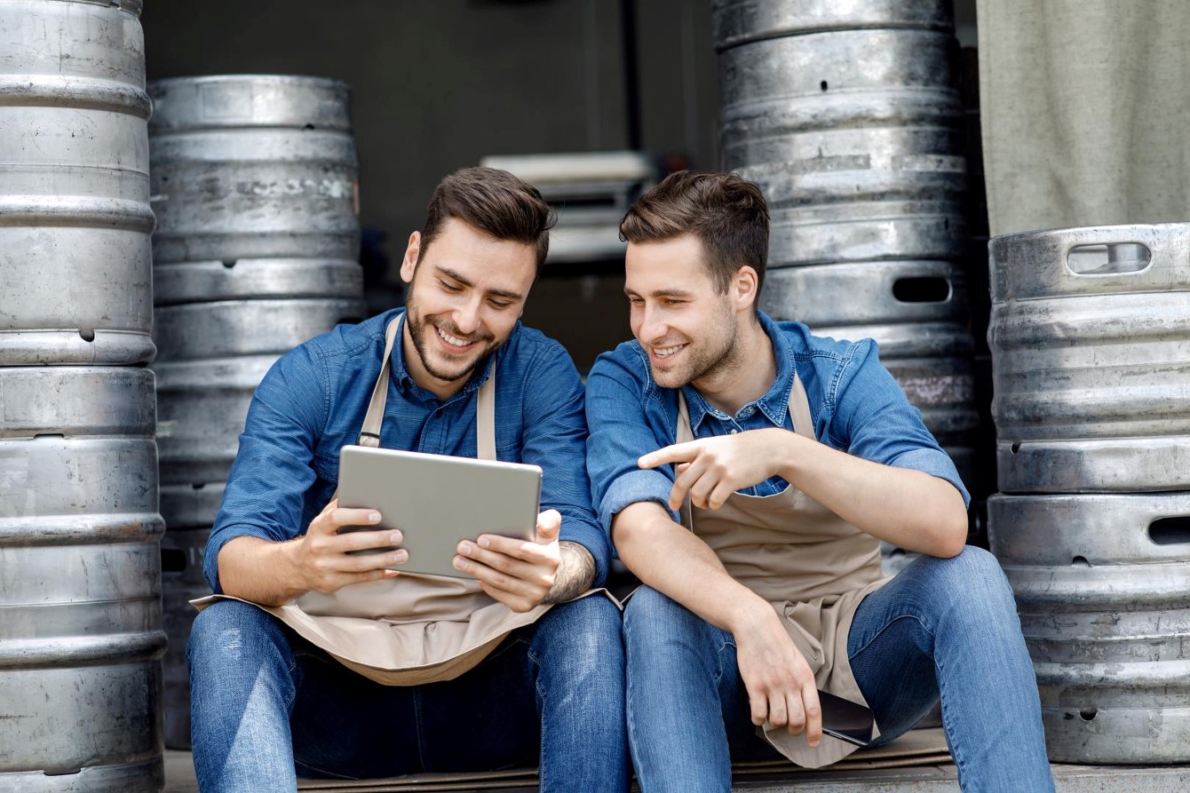 Employees using tablet in brewery